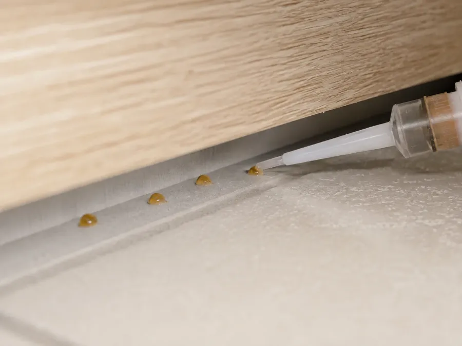 Präzise gesetzte Gelköderpunkte in einem verborgenen Küchenspalt